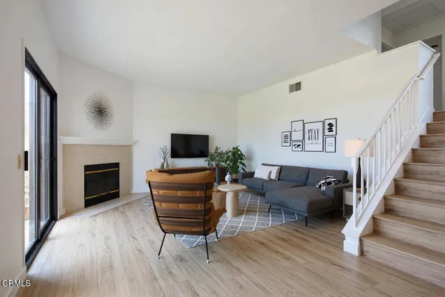 a living room with furniture a fireplace and a flat screen tv