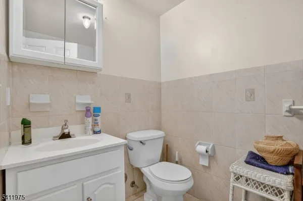 a bathroom with a toilet a sink and a mirror