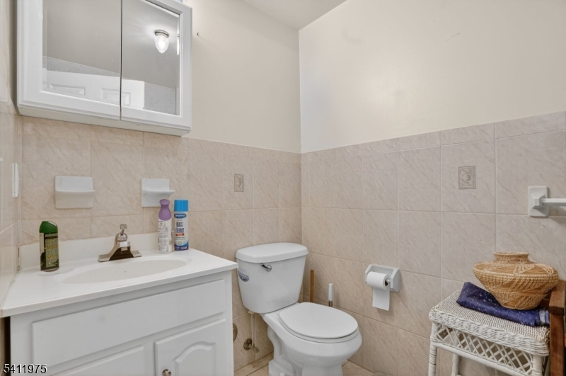 532 Walnut Street Elizabeth, NJ 07201 - Photo 13 of 15 a bathroom with a toilet a sink and a mirror