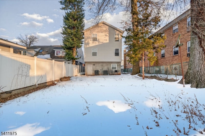 532 Walnut Street Elizabeth, NJ 07201 - Photo 15 of 15 a view of a white house with a snow on the road