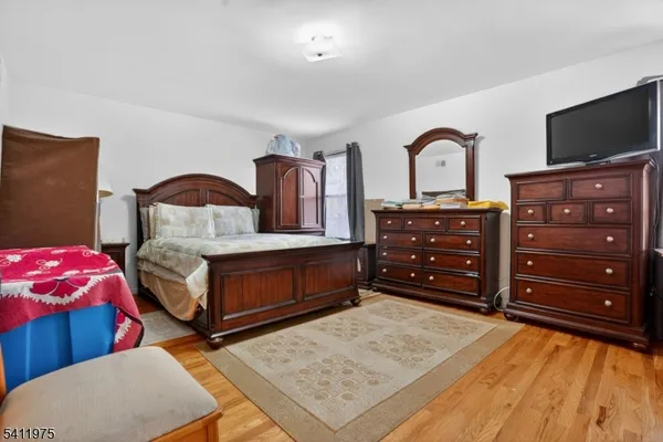 a bedroom with a bed and a television
