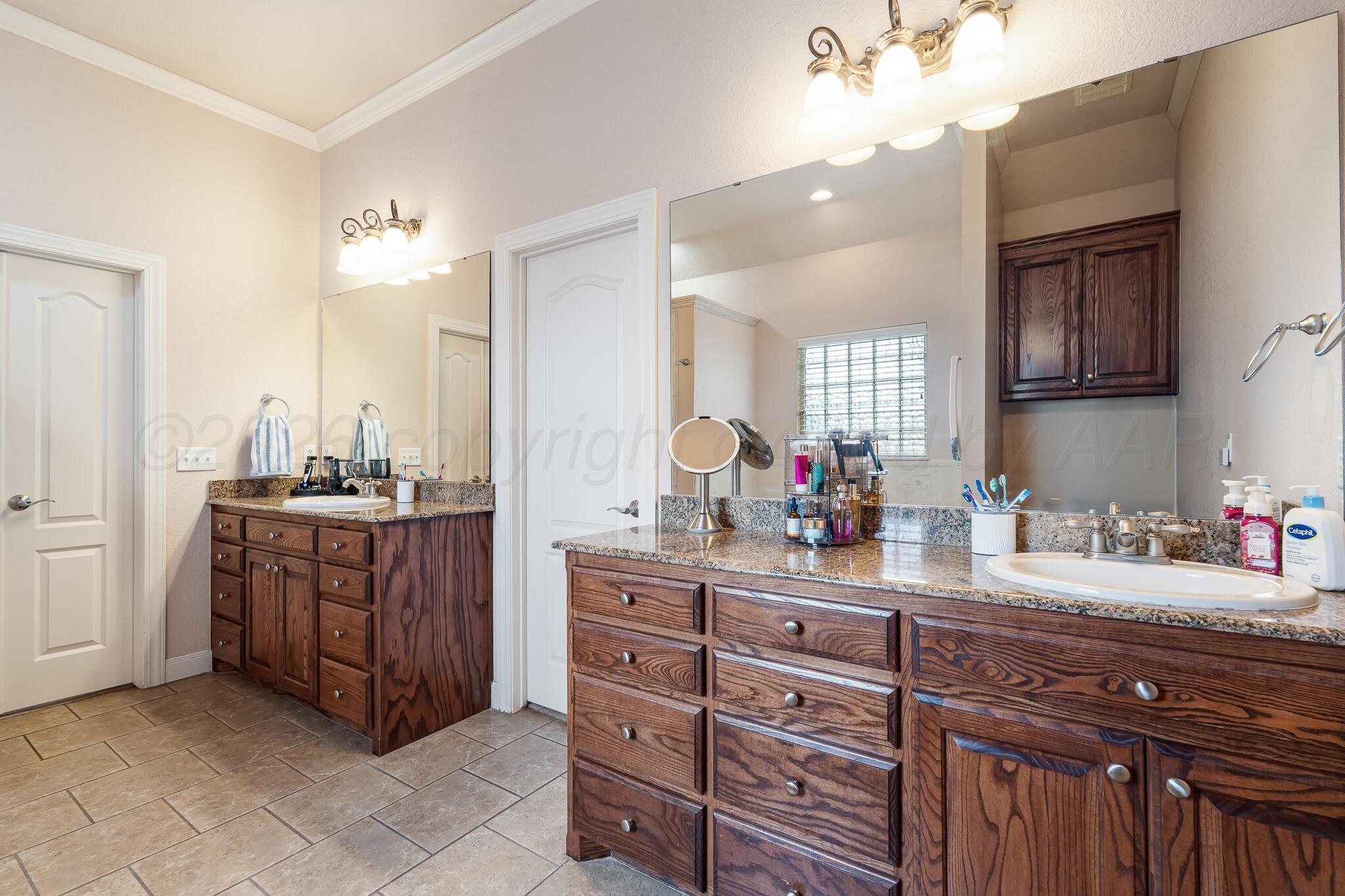 5008 Wesley Road Amarillo, TX 79119 - Photo 26 of 47 a kitchen with a sink and cabinets