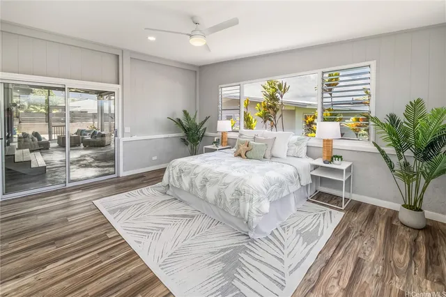 a bedroom with a large bed and a large window