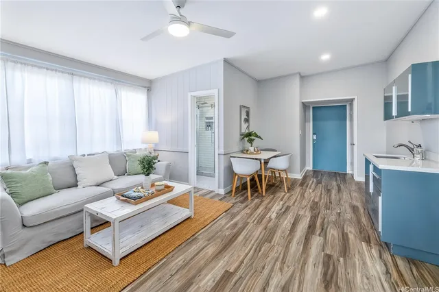 a living room with furniture and wooden floor