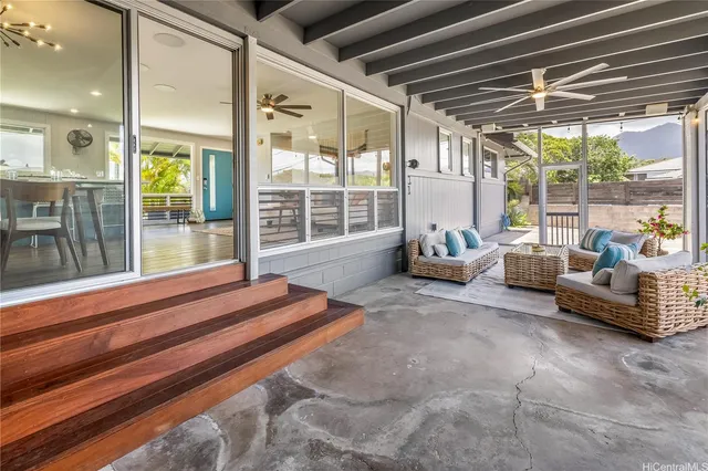 a bedroom with furniture and large windows