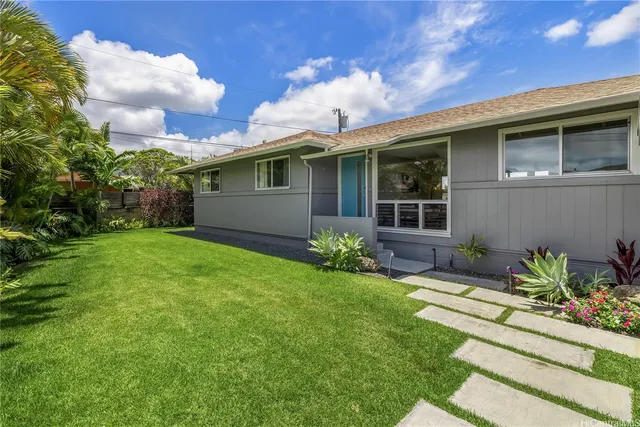 a front view of a house with garden