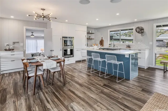 a large kitchen with a table and chairs in it