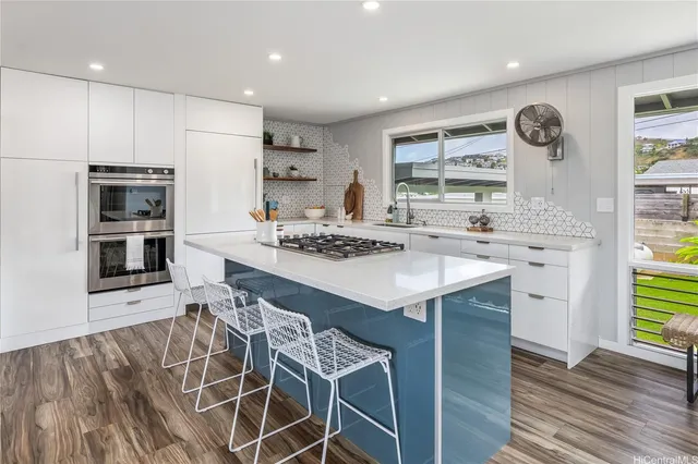 a kitchen with a sink appliances and cabinets
