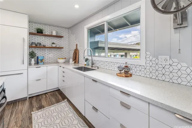 a kitchen with a sink cabinets and window