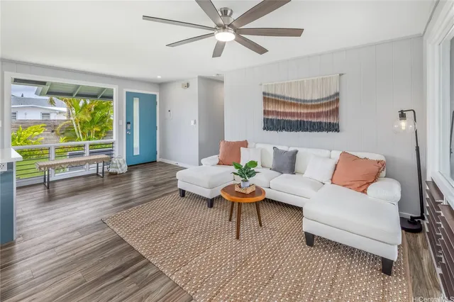 a living room with furniture and a wooden floor
