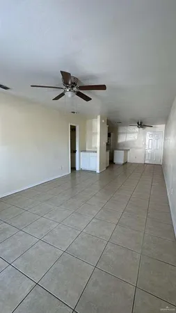a view of a livingroom with a ceiling fan and window