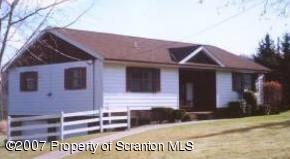 1066 Cortez Road Lake Ariel, PA 18436 - Photo 1 of 1 a front view of a house with a garden