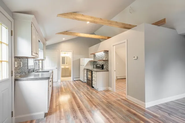 a kitchen with a refrigerator and a sink