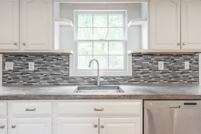 a kitchen with granite countertop a sink and a window