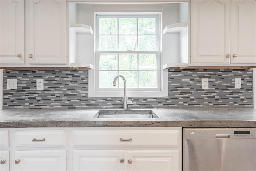 87 Brookfield Road, Unit 1 Charlton, MA 01507 - Photo 11 of 17 a kitchen with granite countertop a sink and a window