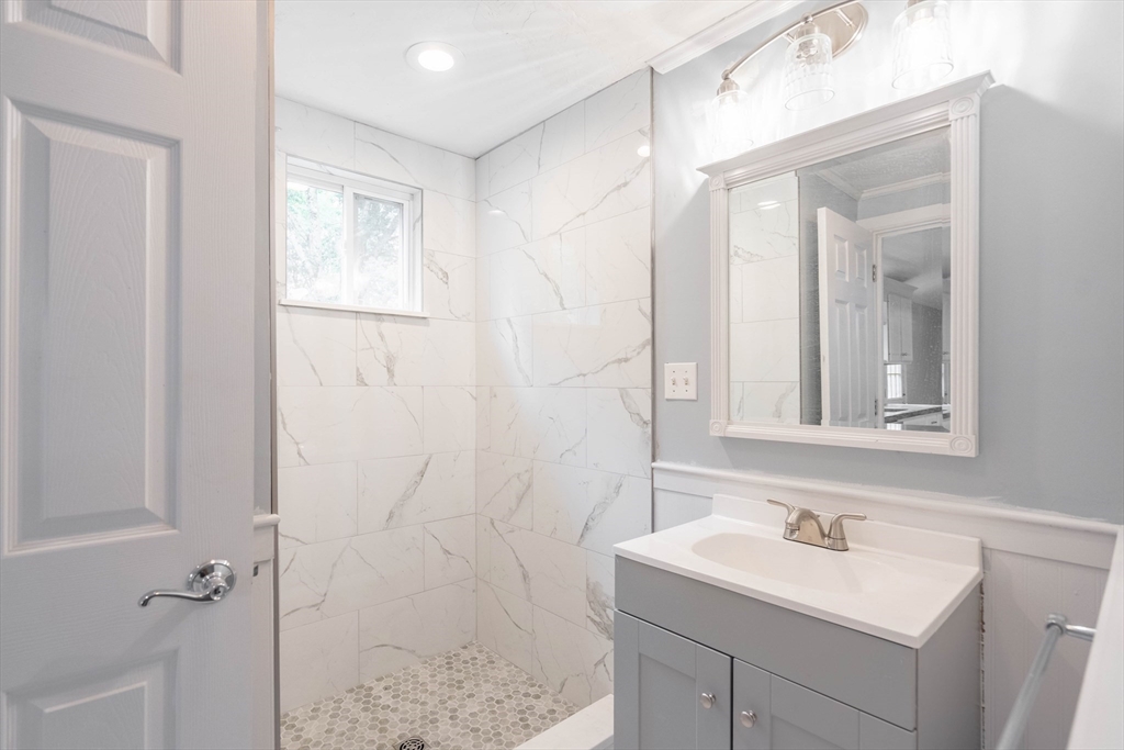 87 Brookfield Road, Unit 1 Charlton, MA 01507 - Photo 13 of 17 a bathroom with a sink a vanity and a mirror
