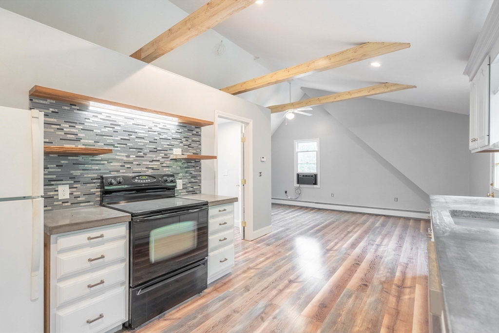 87 Brookfield Road, Unit 1 Charlton, MA 01507 - Photo 15 of 17 a kitchen with granite countertop a stove and a sink