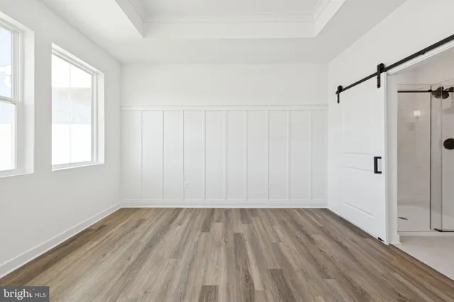 a view of a room with wooden floor closet and windows