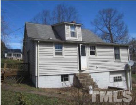 1027 Cavel Chub Lake Road Roxboro, NC 27574 - Photo 2 of 17 a front view of a house with a yard