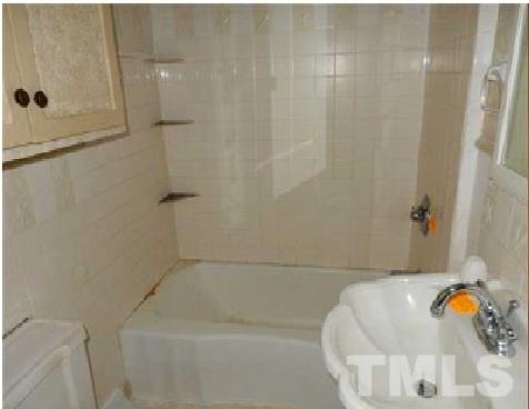 1027 Cavel Chub Lake Road Roxboro, NC 27574 - Photo 13 of 17 a bathroom with a tub and shower