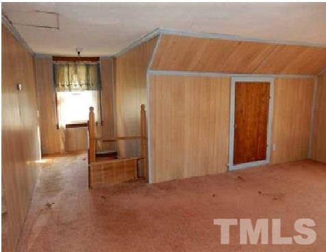 1027 Cavel Chub Lake Road Roxboro, NC 27574 - Photo 14 of 17 an empty room with windows & cabinet