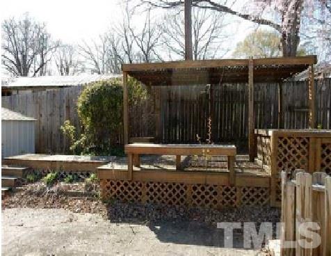 1027 Cavel Chub Lake Road Roxboro, NC 27574 - Photo 4 of 17 a view of a bench with wooden fence