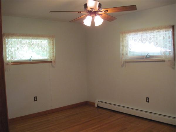 36 Grove Street Marshfield, MA 02050 - Photo 8 of 11 an empty room with a window and wooden floor