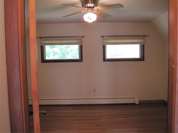 36 Grove Street Marshfield, MA 02050 - Photo 10 of 11 an empty room with wooden floor fan and windows