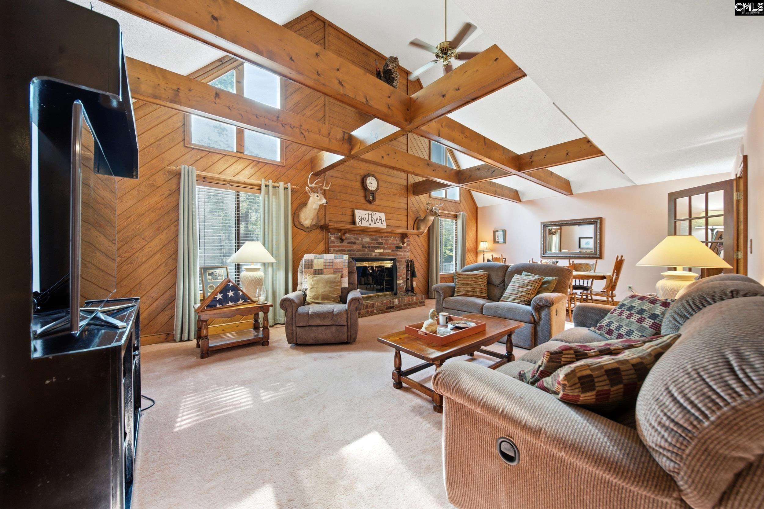 4324 Syrup Mill Road Ridgeway, SC 29130 - Photo 5 of 61 a living room with furniture a fireplace and a chandelier