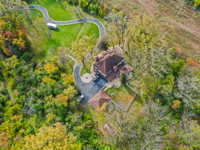 an aerial view of a house with a backyard space and street view
