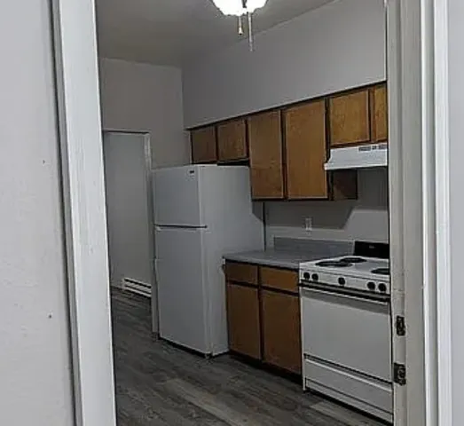 a kitchen with a refrigerator and a stove