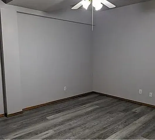 a view of a small space with wooden floor and a window