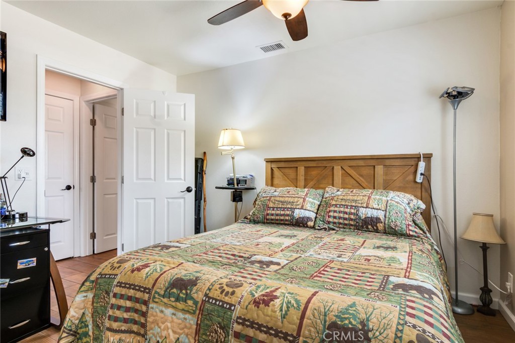 3198 Bexfield Court Riverside, CA 92503 - Photo 15 of 22 a bedroom with a bed and wooden floor