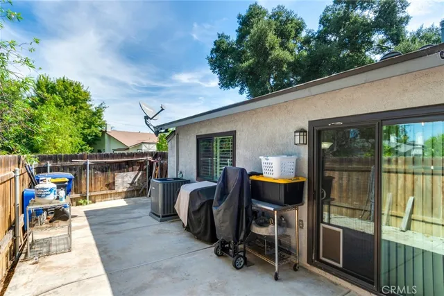 a view of a patio with a table and chairs