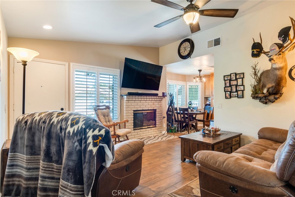 3198 Bexfield Court Riverside, CA 92503 - Photo 7 of 22 a living room with furniture a fireplace and a large window