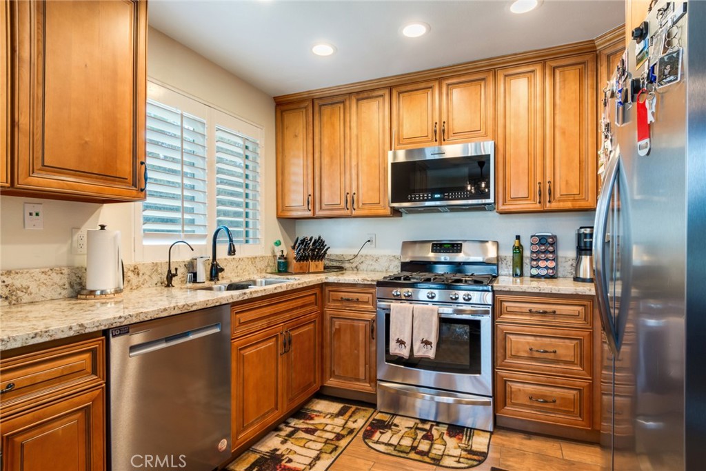 3198 Bexfield Court Riverside, CA 92503 - Photo 8 of 22 a kitchen with stainless steel appliances granite countertop a stove a sink and a microwave