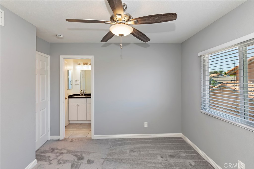 9152 Owari Lane Riverside, CA 92508 - Photo 12 of 20 a view of a room with a ceiling fan and a window