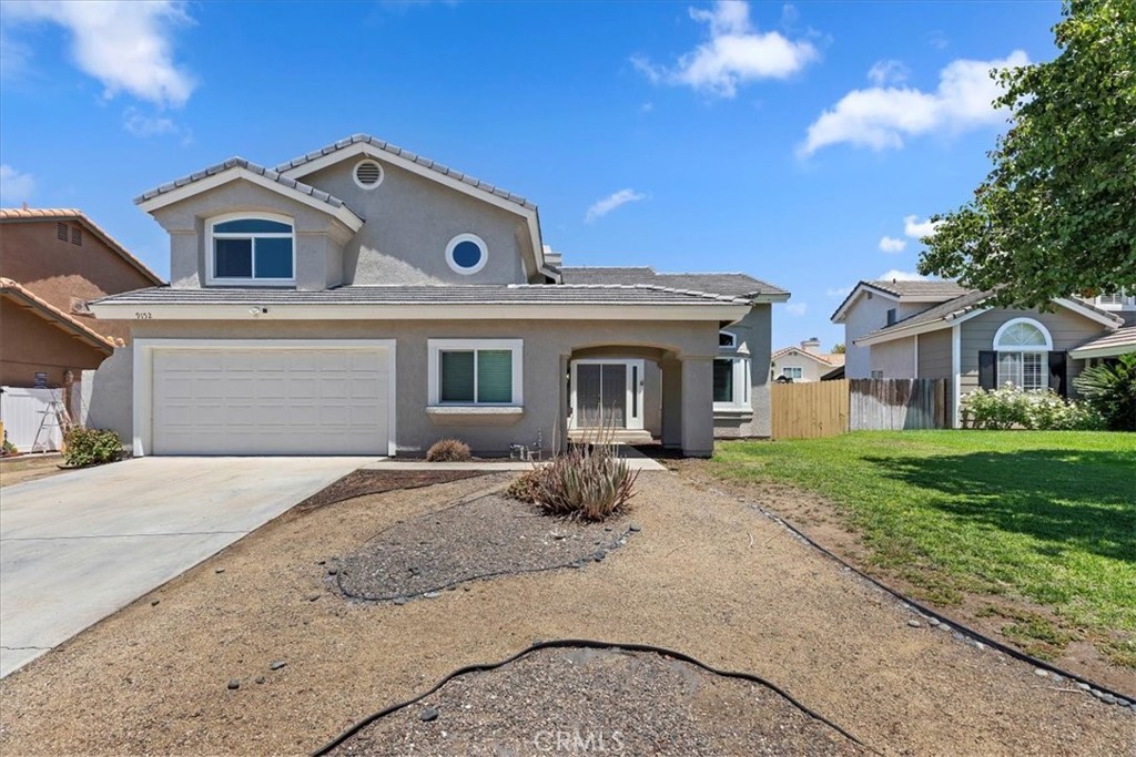 9152 Owari Lane Riverside, CA 92508 - Photo 3 of 20 a front view of a house with a yard and garage