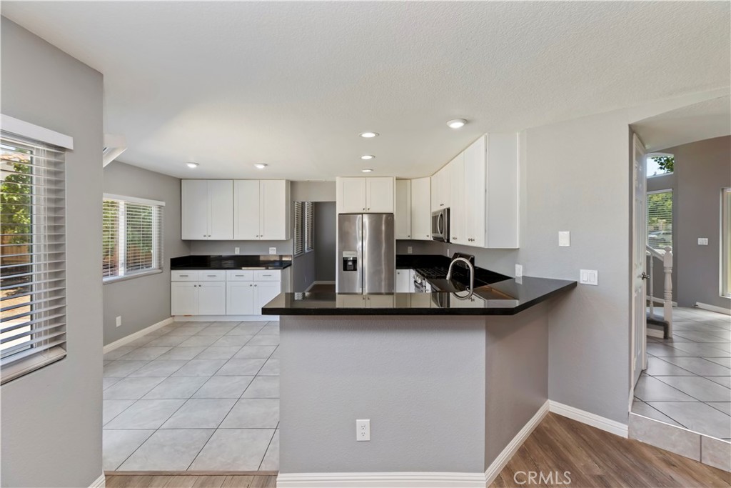 9152 Owari Lane Riverside, CA 92508 - Photo 5 of 20 a kitchen with stainless steel appliances kitchen island a sink a stove and refrigerator