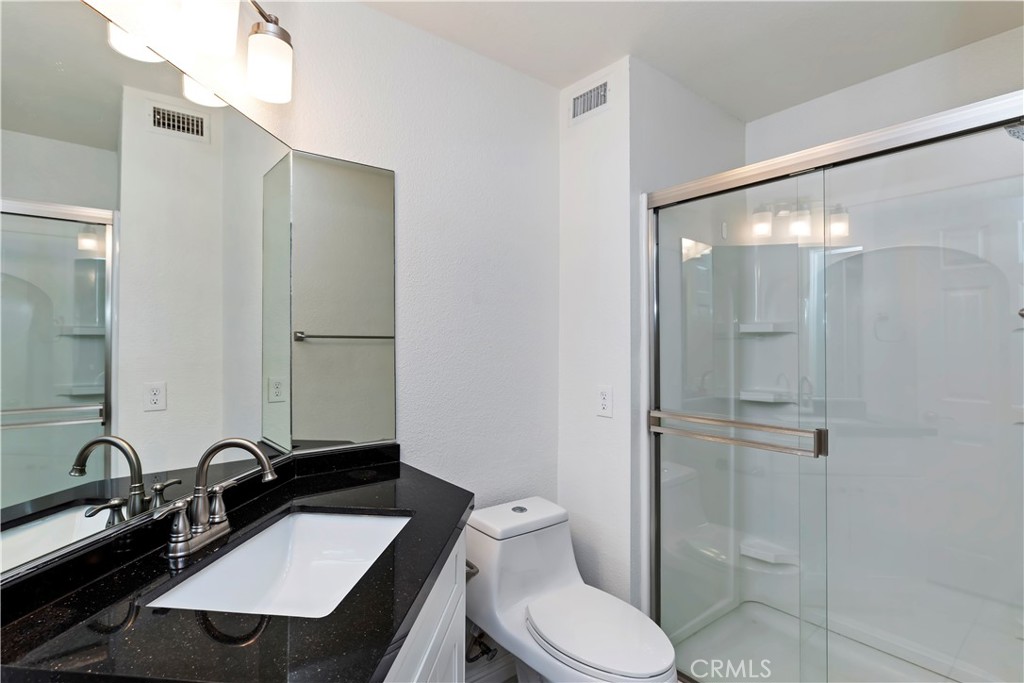 9152 Owari Lane Riverside, CA 92508 - Photo 7 of 20 a bathroom with a sink a toilet and shower