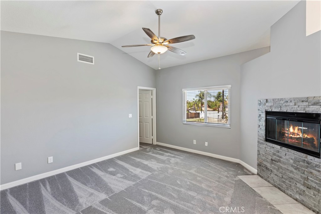 9152 Owari Lane Riverside, CA 92508 - Photo 8 of 20 a view of an empty room with window and fireplace