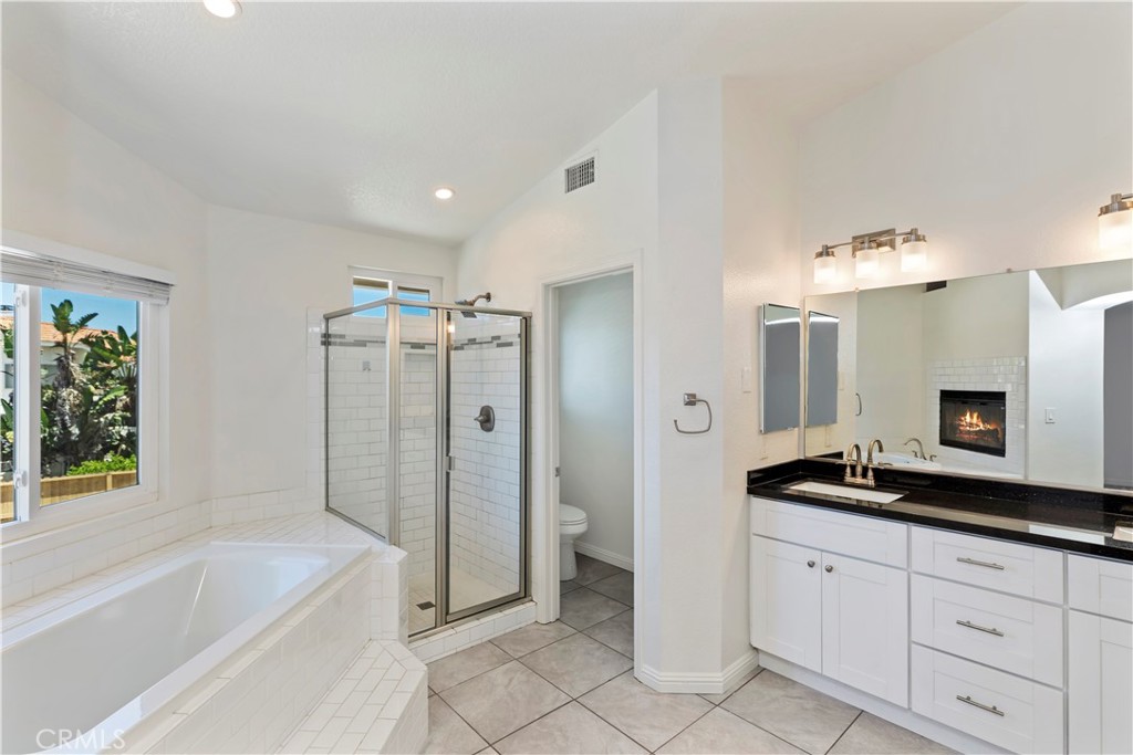 9152 Owari Lane Riverside, CA 92508 - Photo 10 of 20 a spacious bathroom with a bathtub sink and mirror