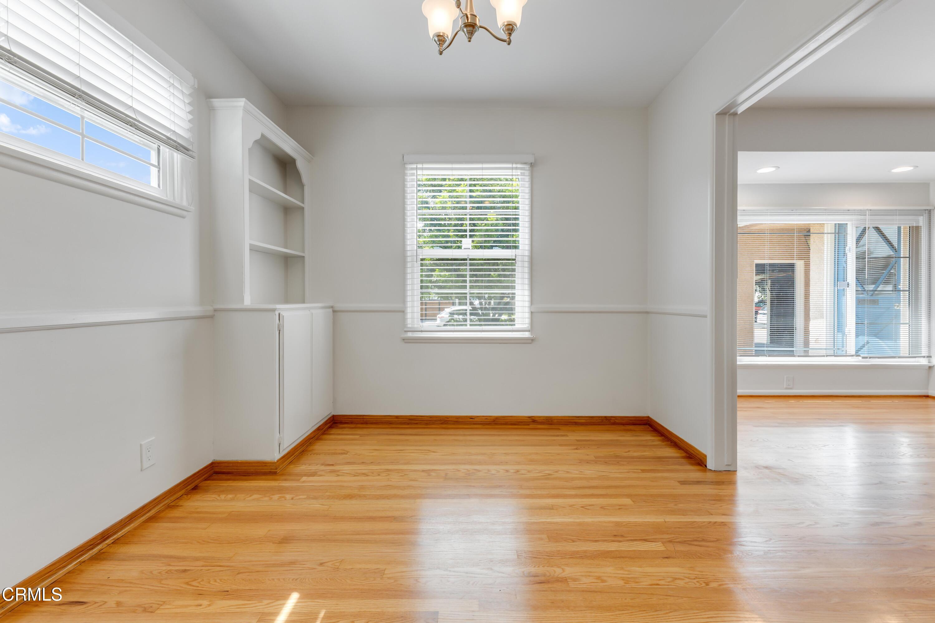 5622 Bellingham Avenue Valley Village, CA 91607 - Photo 12 of 24 a view of empty room with wooden floor and fan
