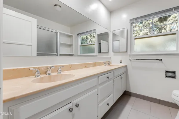 a spacious bathroom with a sink and a mirror