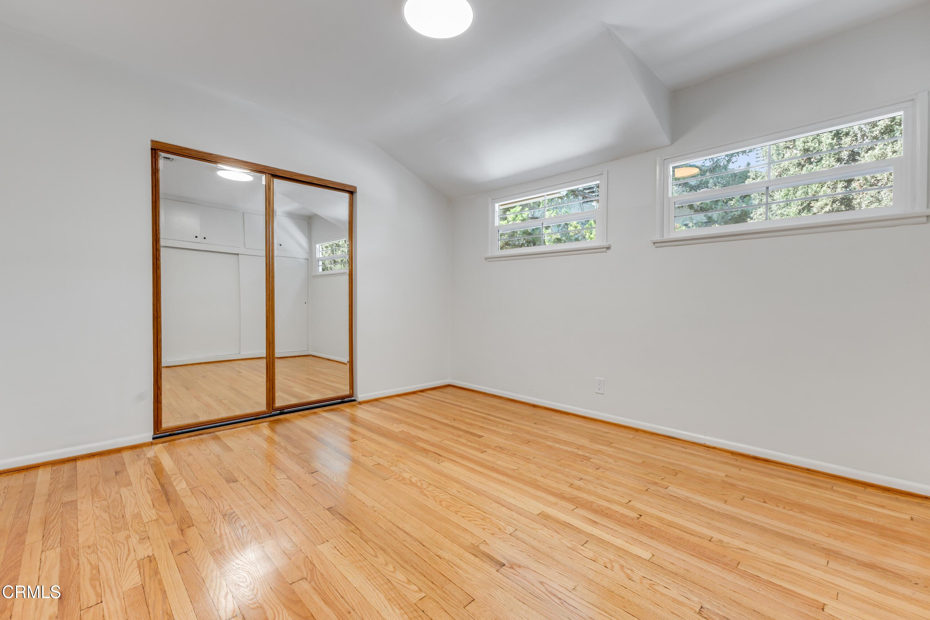 5622 Bellingham Avenue Valley Village, CA 91607 - Photo 16 of 24 a view of an empty room with wooden floor and a window
