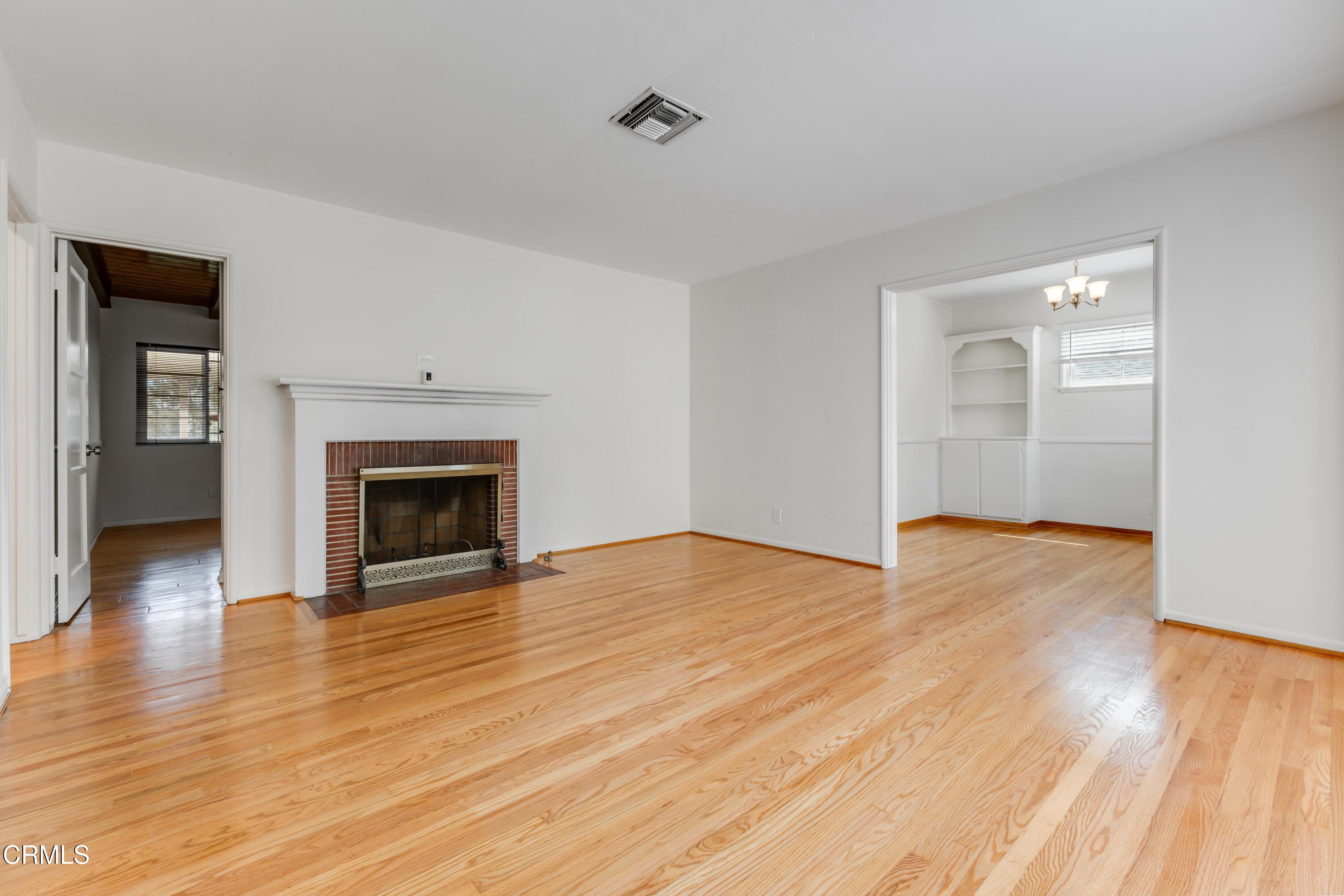 5622 Bellingham Avenue Valley Village, CA 91607 - Photo 2 of 24 a view of empty room with wooden floor and fireplace