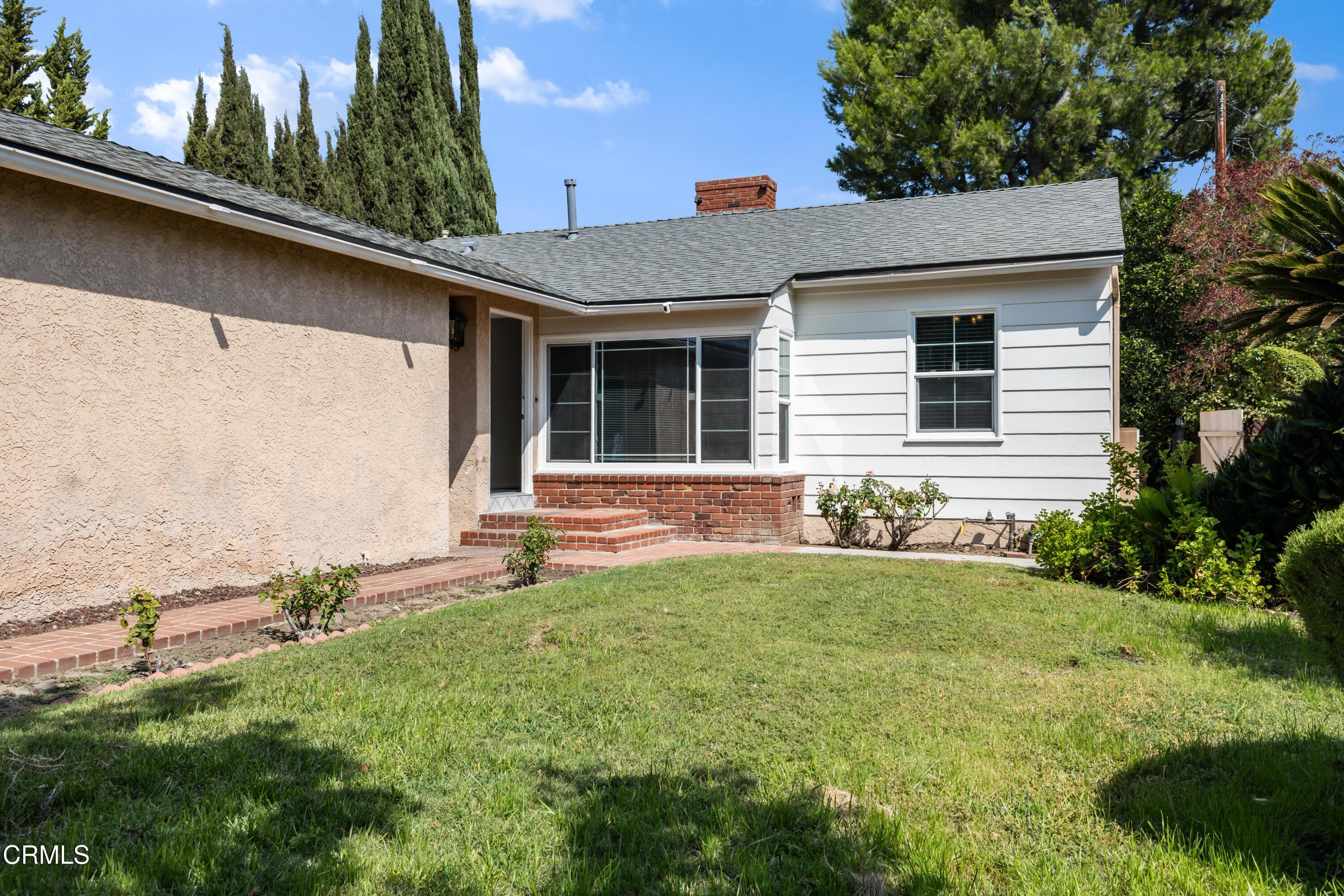 5622 Bellingham Avenue Valley Village, CA 91607 - Photo 24 of 24 a front view of a house with a yard
