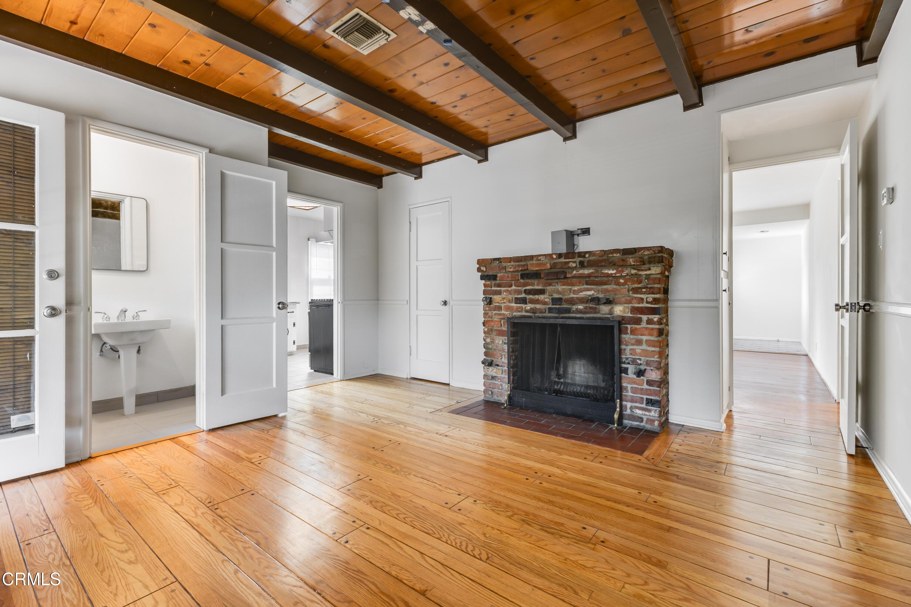 5622 Bellingham Avenue Valley Village, CA 91607 - Photo 3 of 24 a view of a livingroom with wooden floor and a fireplace
