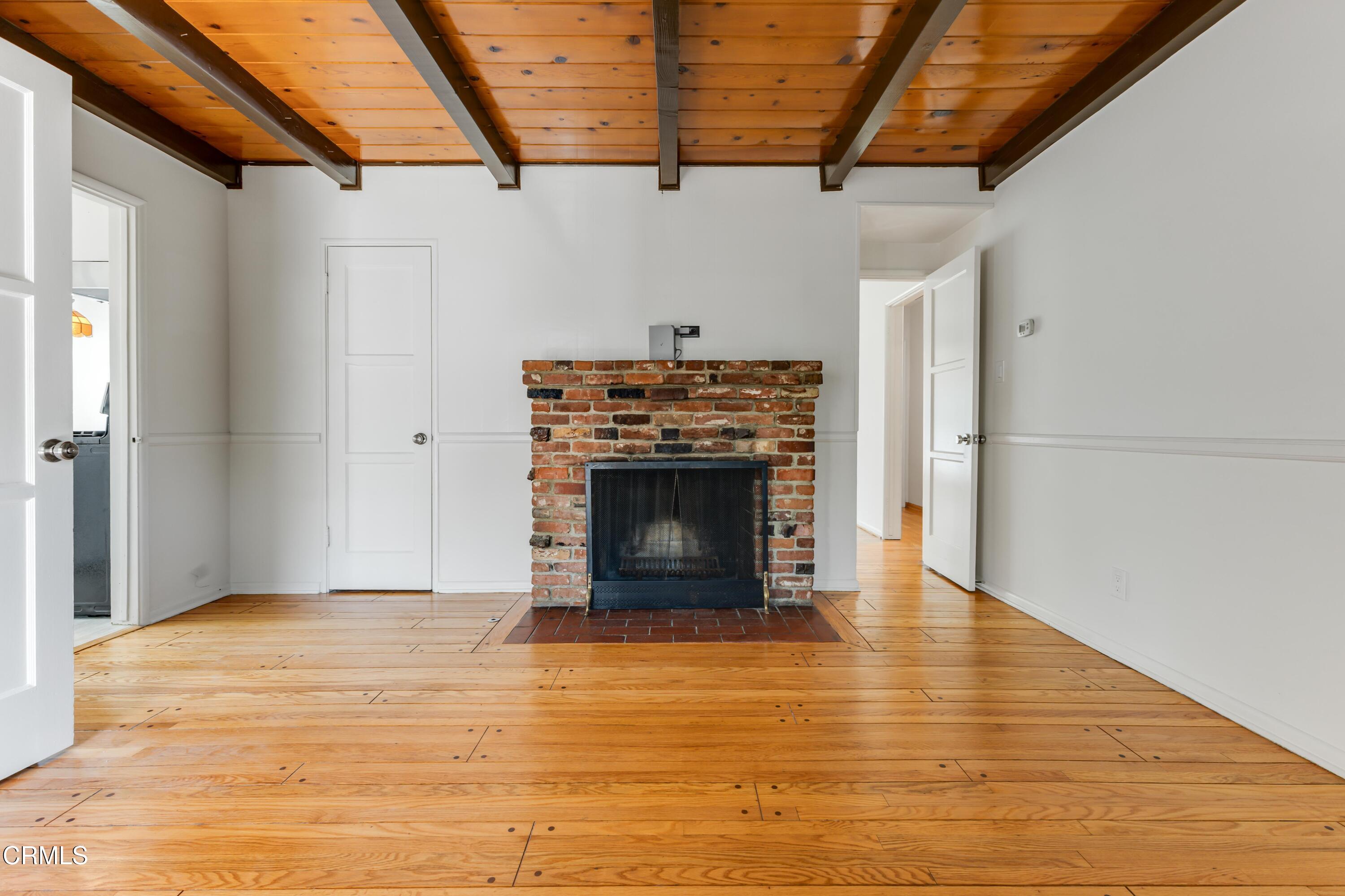 5622 Bellingham Avenue Valley Village, CA 91607 - Photo 4 of 24 a view of an empty room with wooden floor fireplace and a window