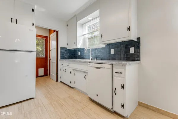 a kitchen with stainless steel appliances a refrigerator and cabinets